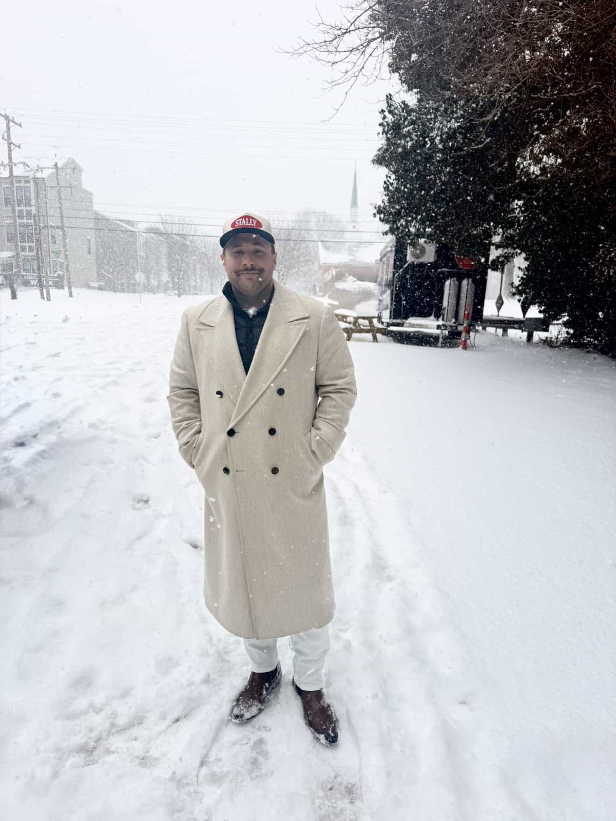Man wearing an All American STALLY hat standing in the snow