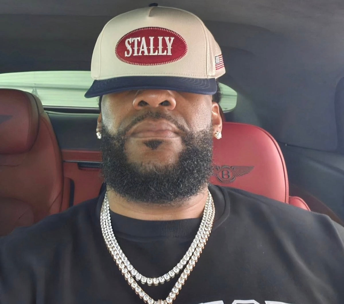 Ty Nsekhe wearing an All American STALLY hat in a Bentley