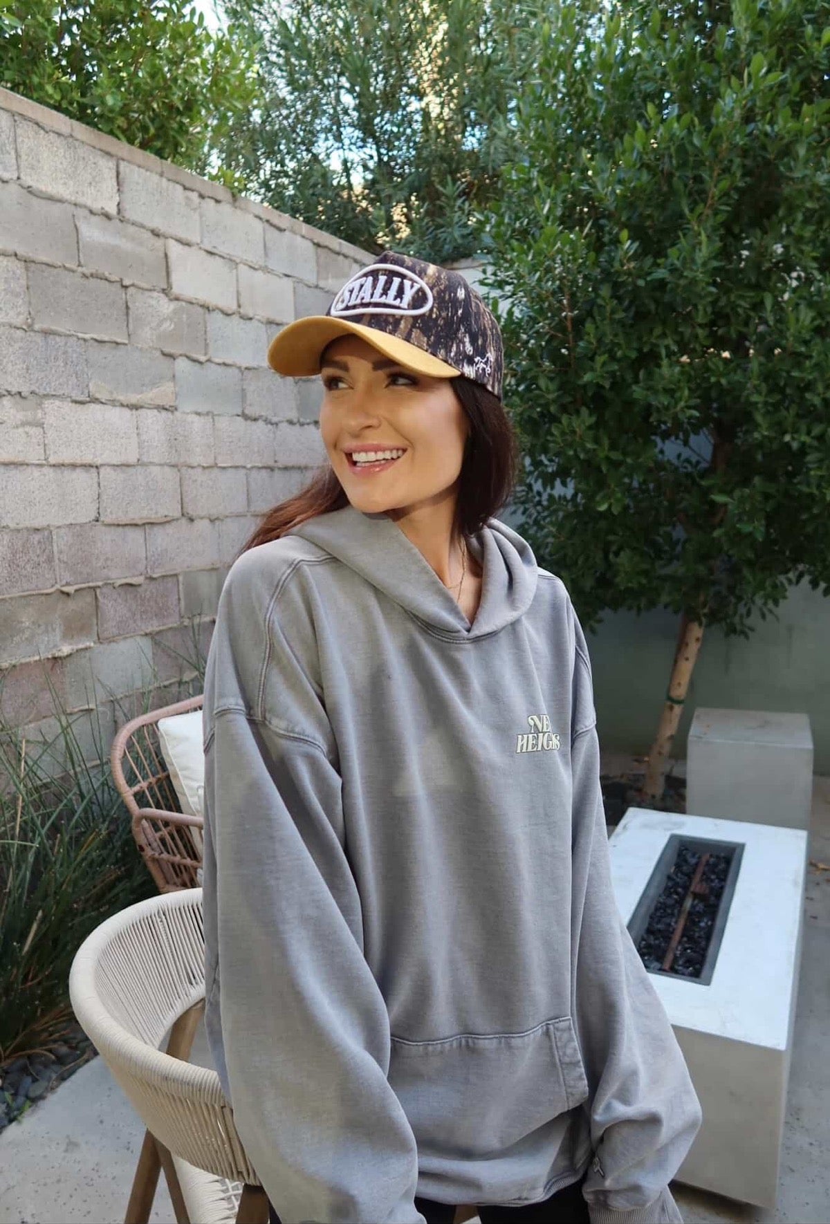 Woman wearing Camo STALLY Hat.