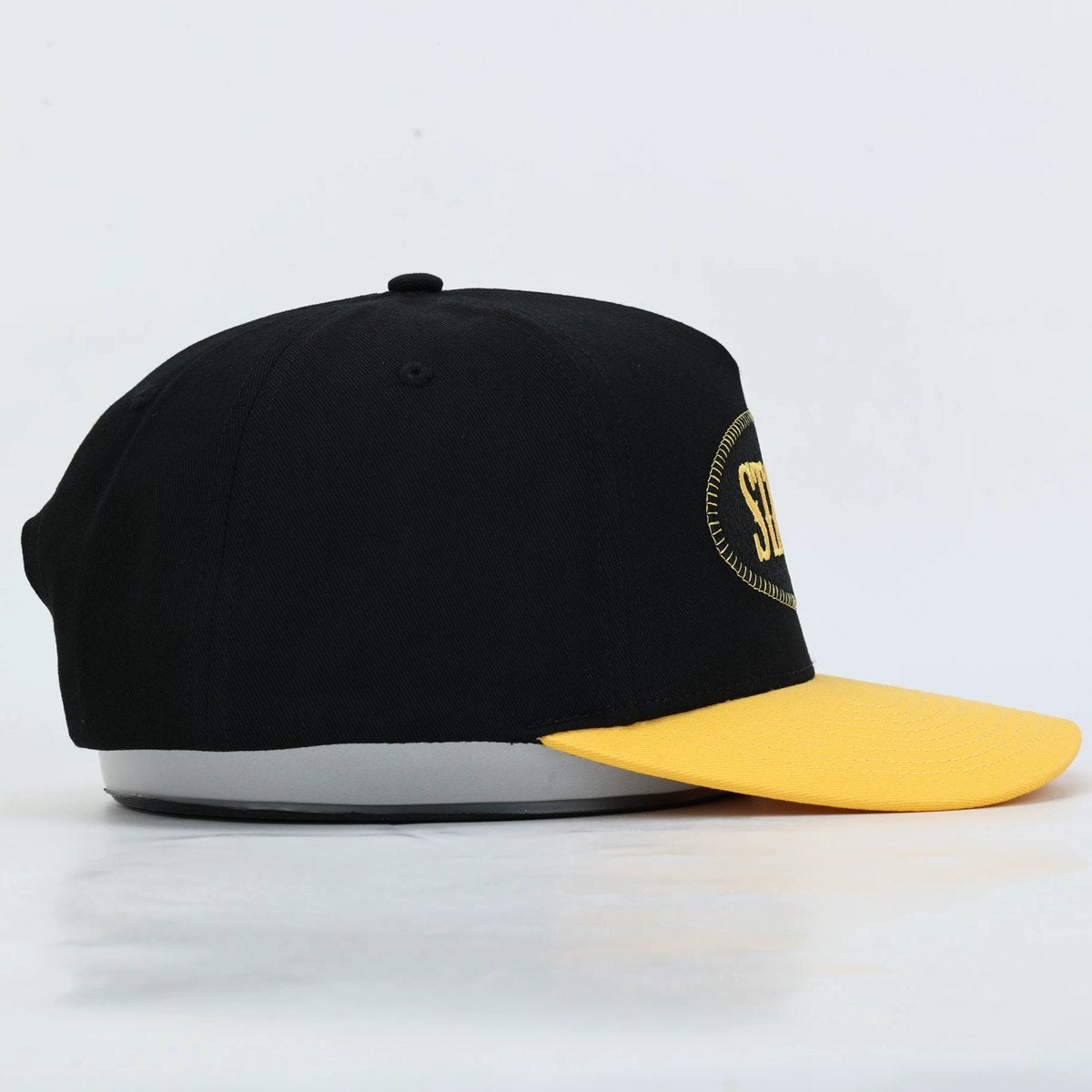 Black and gold Stally hat, side view
