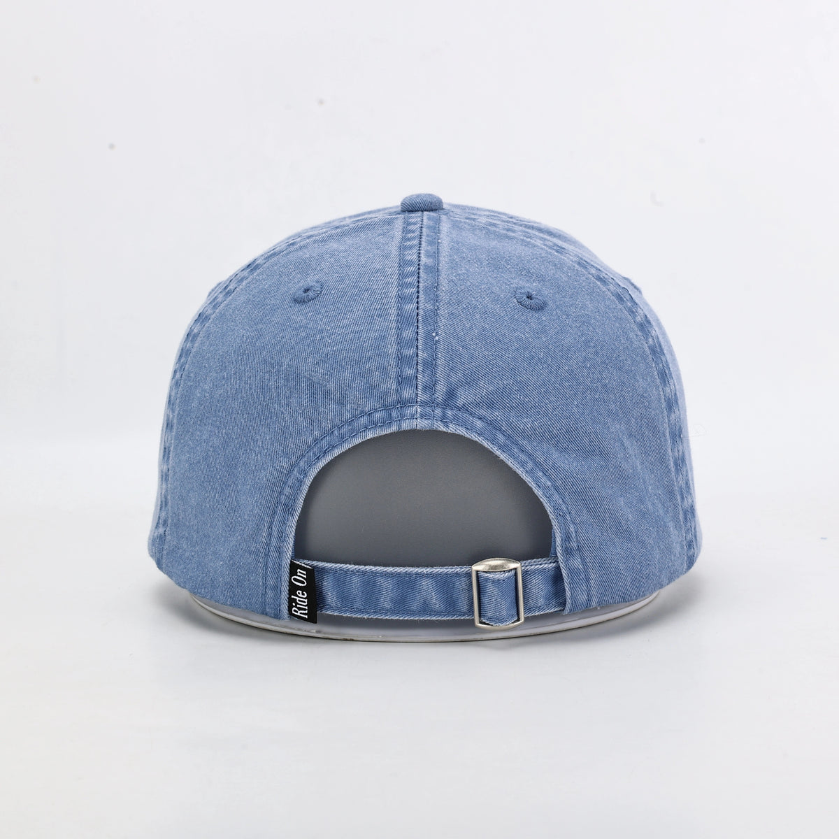 Blue Washed Denim Dad Cap Being Worn Outdoors