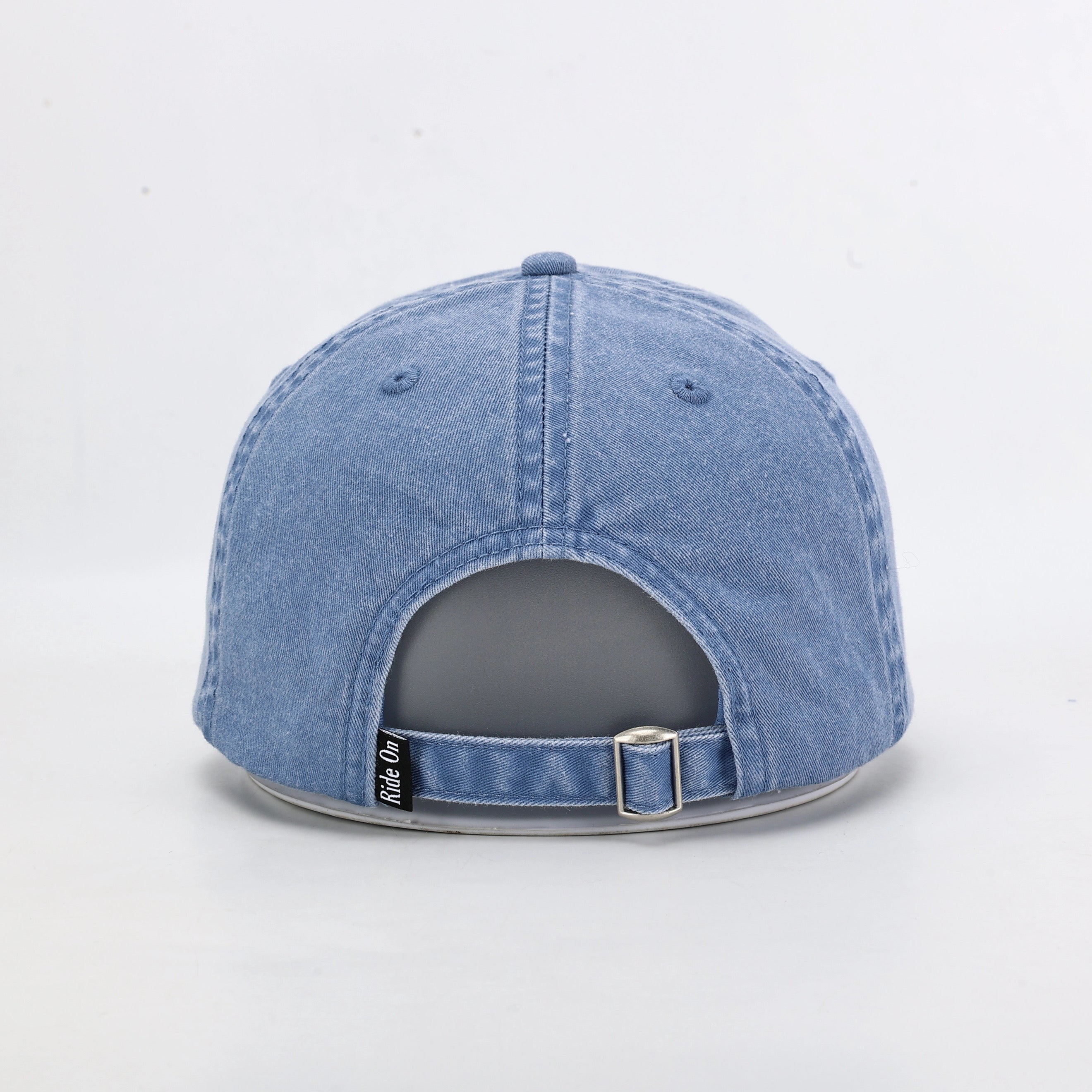 Blue Washed Denim Dad Cap Being Worn Outdoors