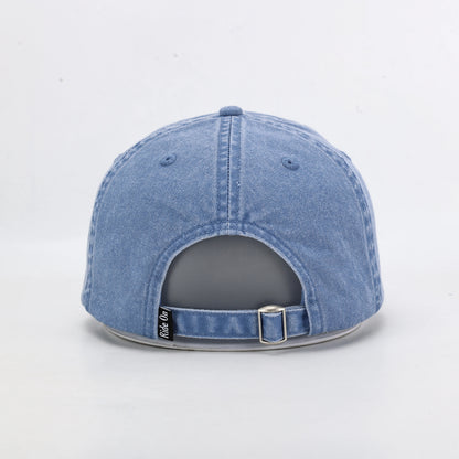 Blue Washed Denim Dad Cap Being Worn Outdoors