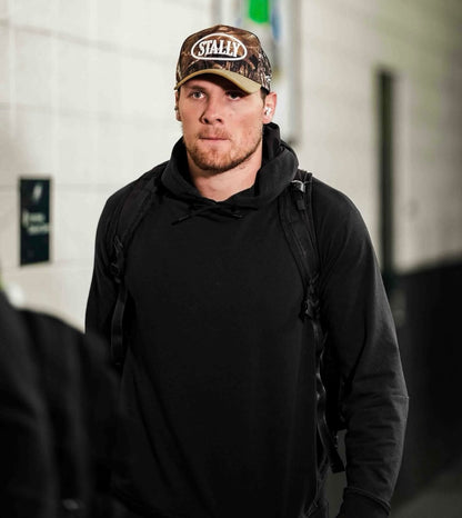 Jack Campbell wearing CAMO STALLY hat walking into professional football stadium to play for the Detroit Lions
