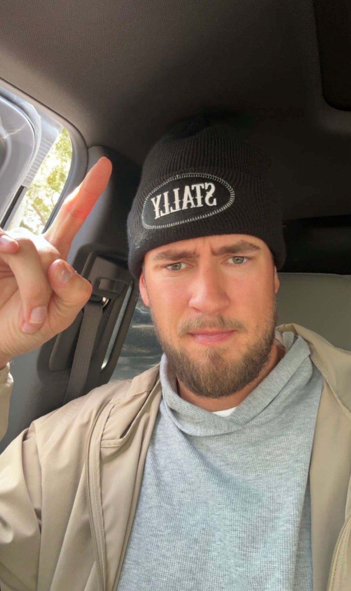 Man wearing a STALLY Frontier Beanie in Black sitting in a vehicle