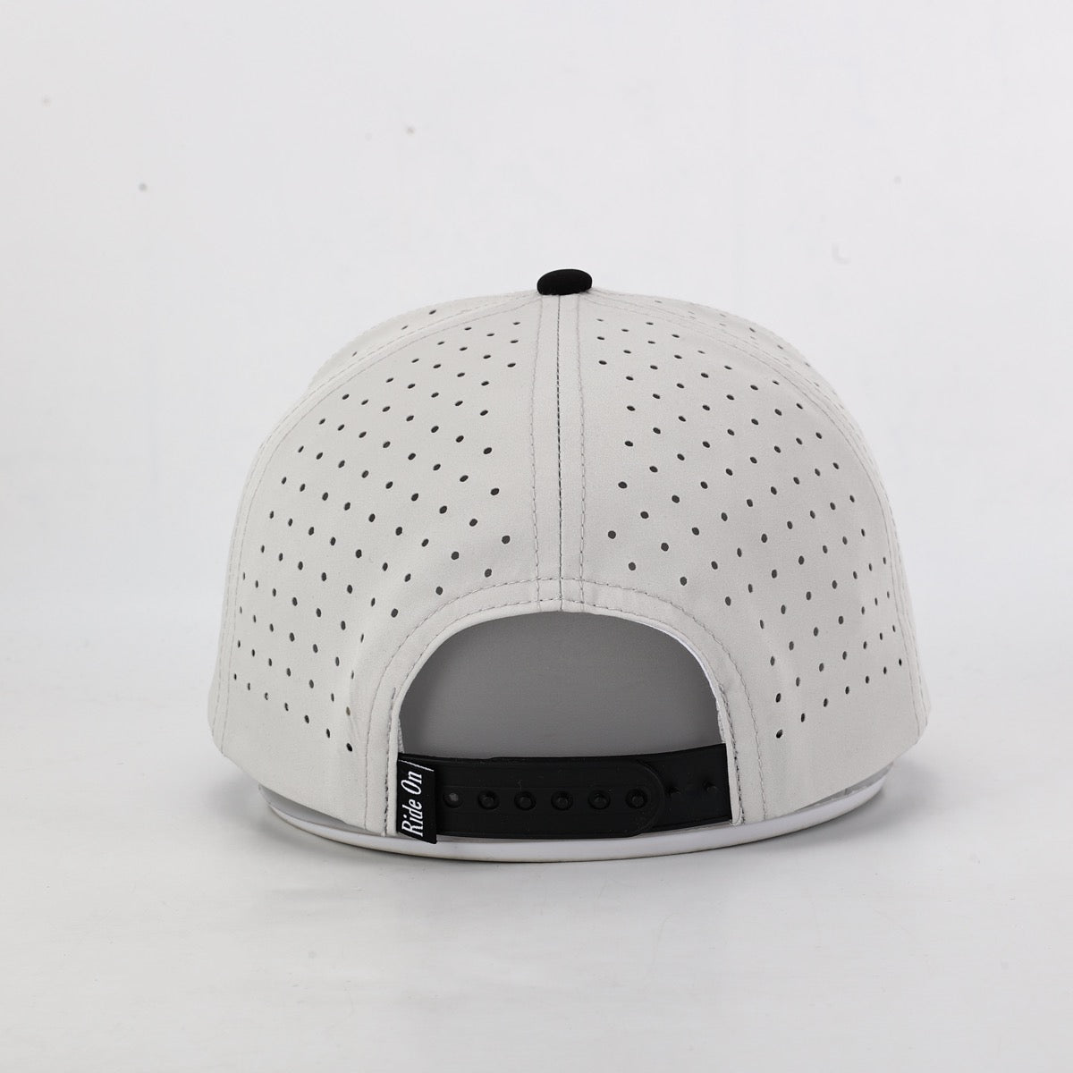 White perforated cap back view on a light gray background
