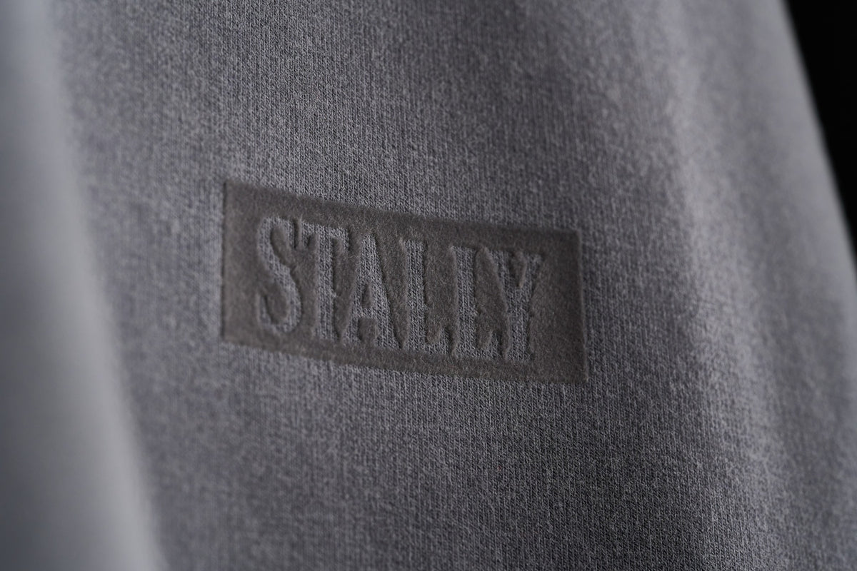 Horsepower Mens Boxy Tee in Iron, tonal flocked STALLY wordmark at the chest, close-up