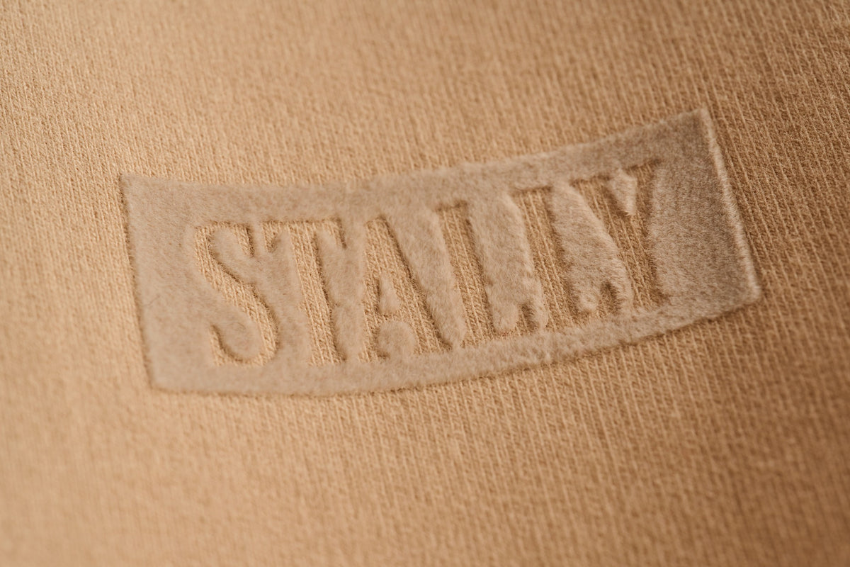 Horsepower Mens Boxy Tee in Saddlewood, tonal flocked STALLY wordmark at the chest, close-up