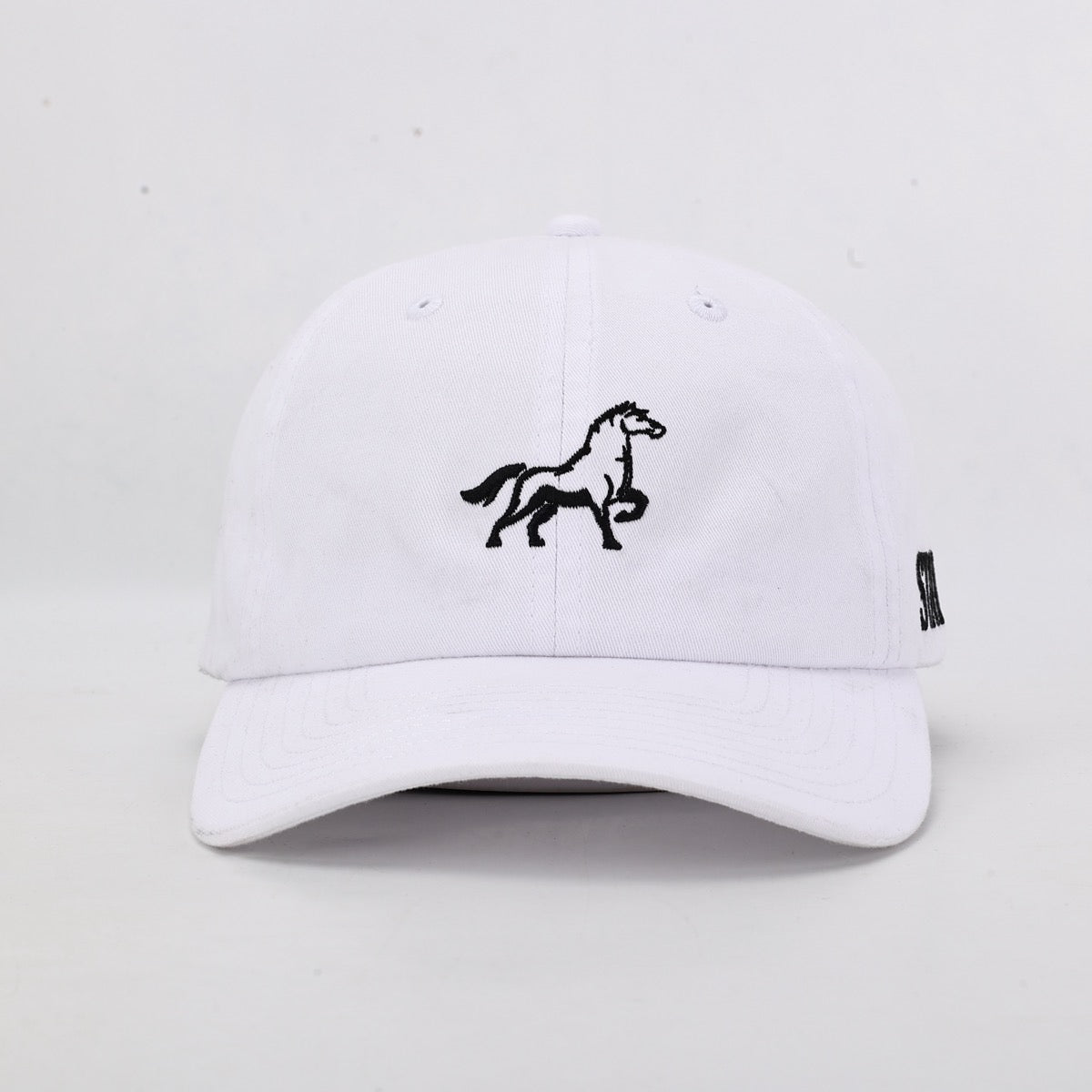 White cap with a black horse emblem on a light gray background