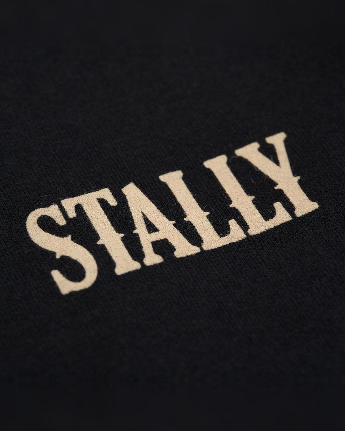 Horsepower Womens Boxy Tee in Coal Black, STALLY wordmark at the chest, close-up