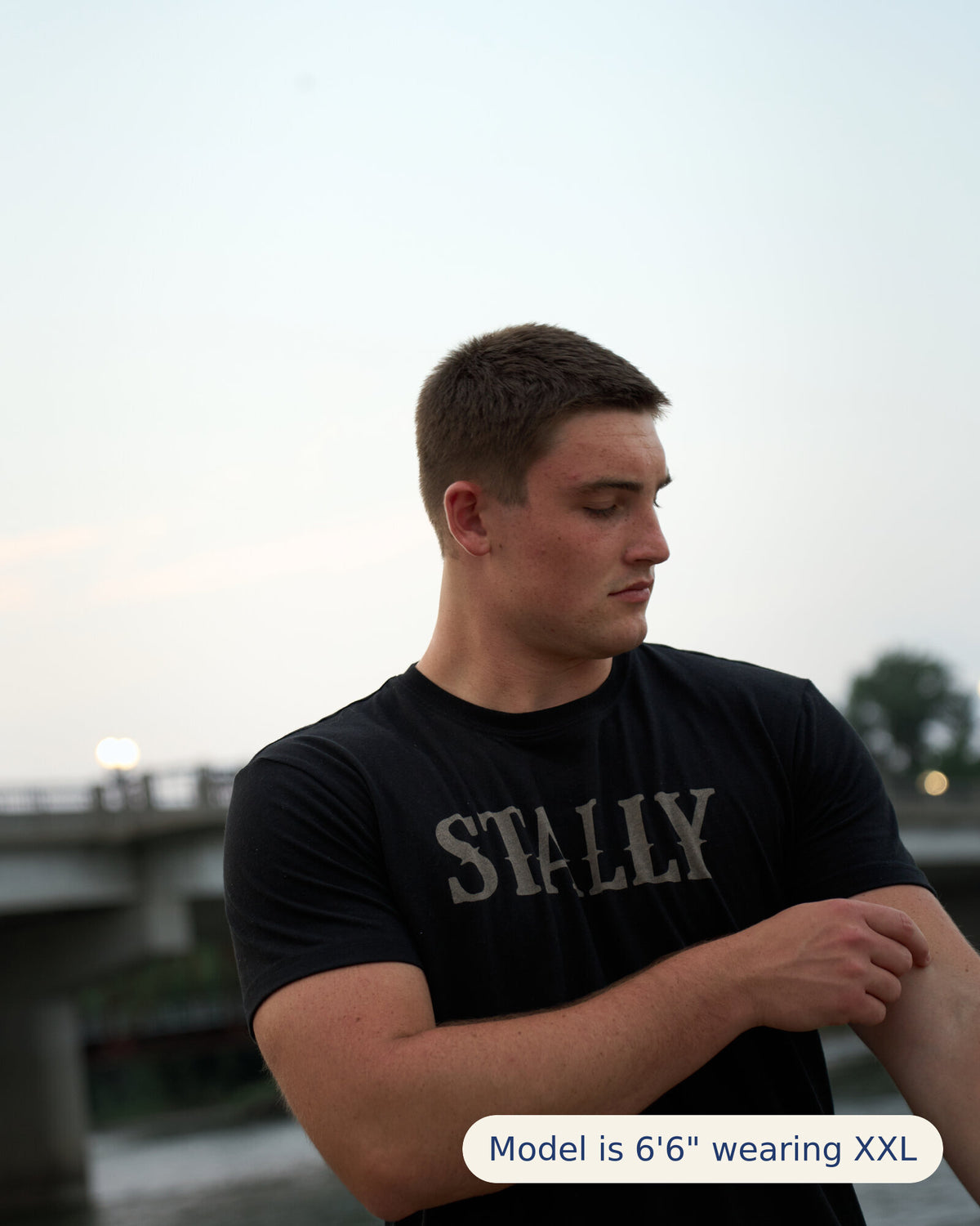 Stally Workhorse Performance Tee in Coal Black worn at the riverfront