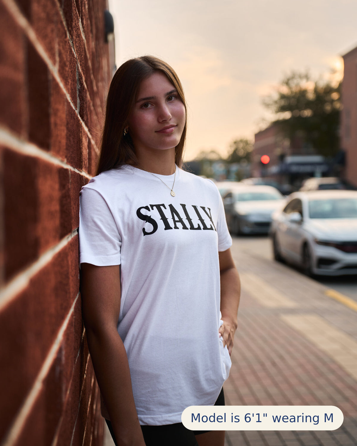 Stally Workhorse Performance Tee in Chalk White worn downtown at sunset
