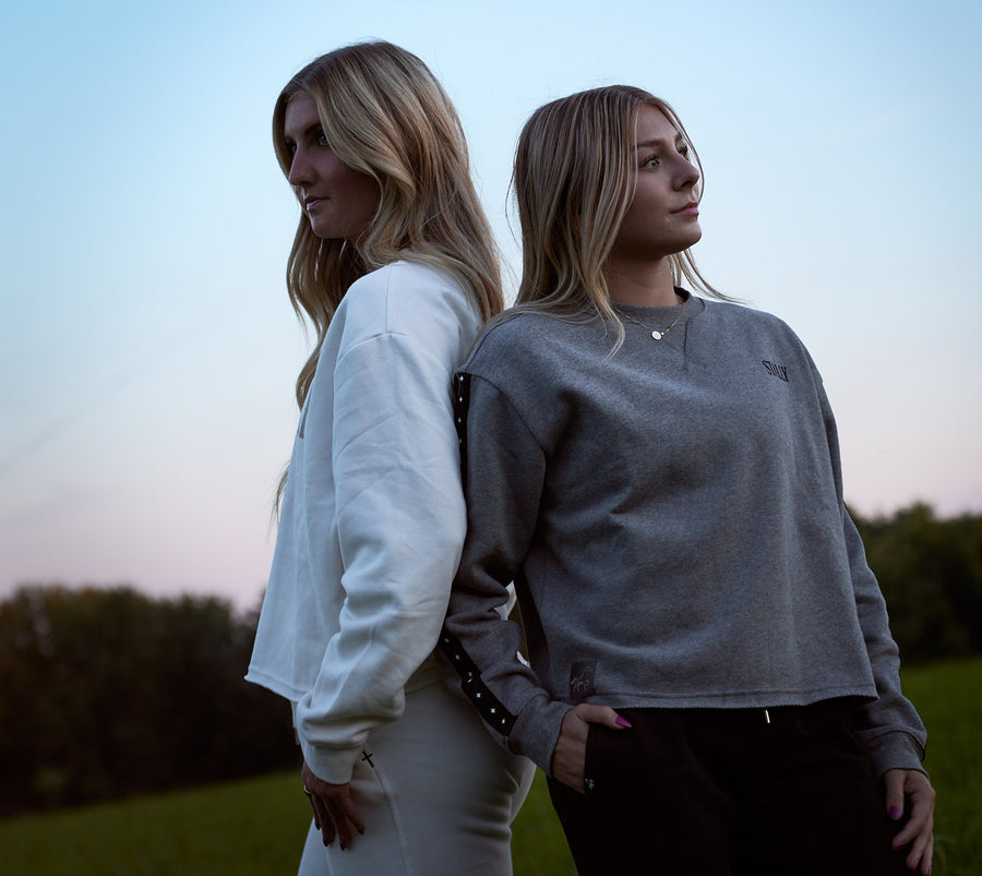 Two women back to back at dusk in Chalk White and Grey Heather Stally Range women's boxy crews