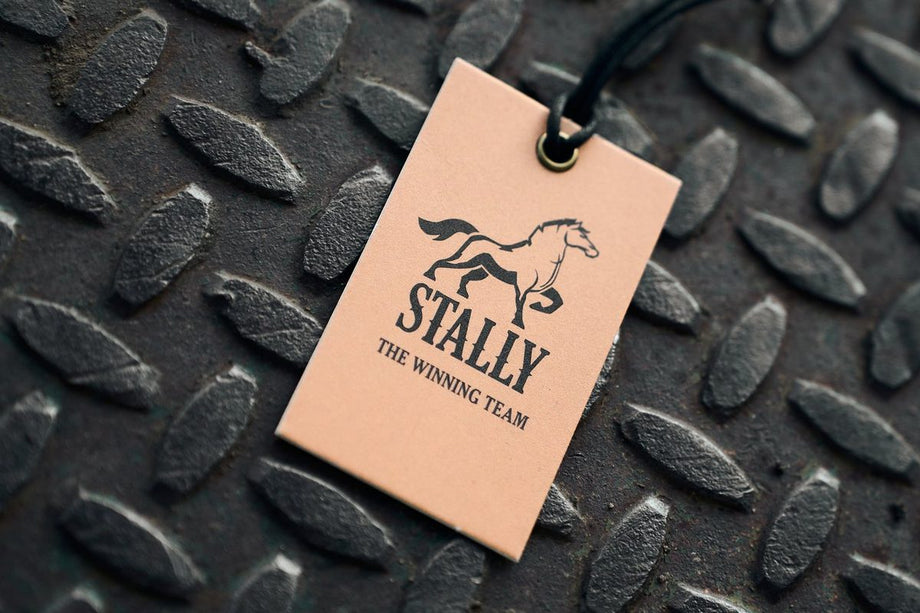 A STALLY hang tag reading The Winning Team, on a steel tread plate