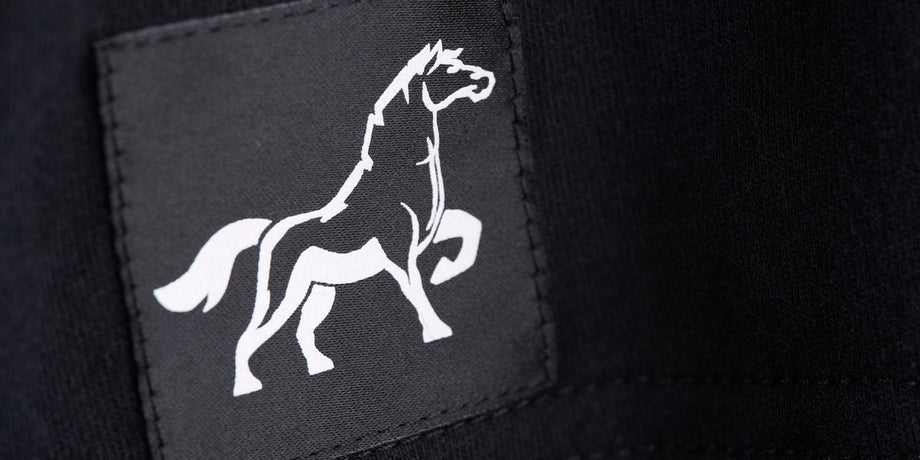 The white Stally horse on a black woven patch